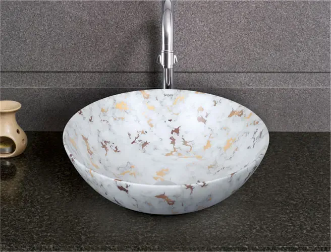 Round basin with a marble pattern on a dark counter